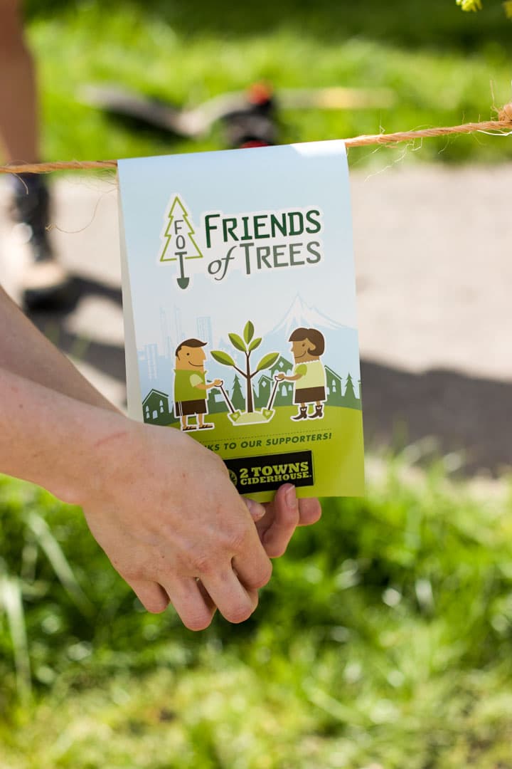 A close up of a "Friends Of Trees - Sponsored by 2 Towns Ciderhouse" sticker around a freshly planted tree.